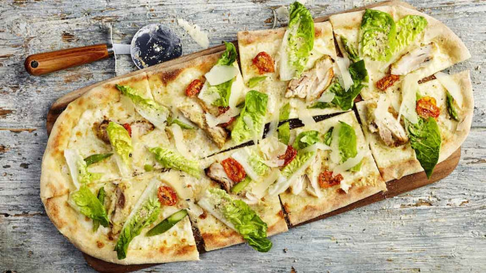 to make salad interesting - by shoving it on top of a pizza